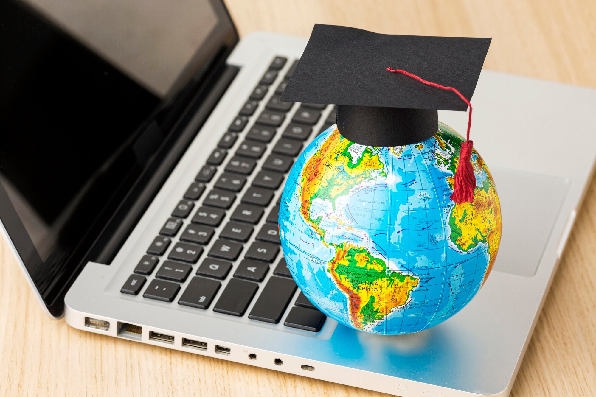 high angle globe with academic cap laptop 23 2148756555